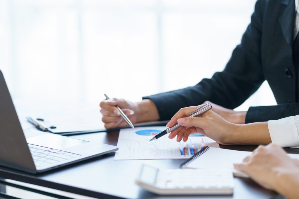 business people analyzes, graphs and charts to examine and analy